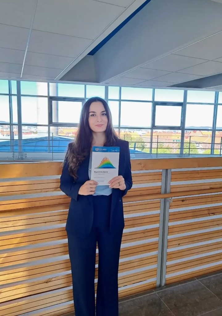 Dr Maria Vittoria Managlia holding her PhD thesis.